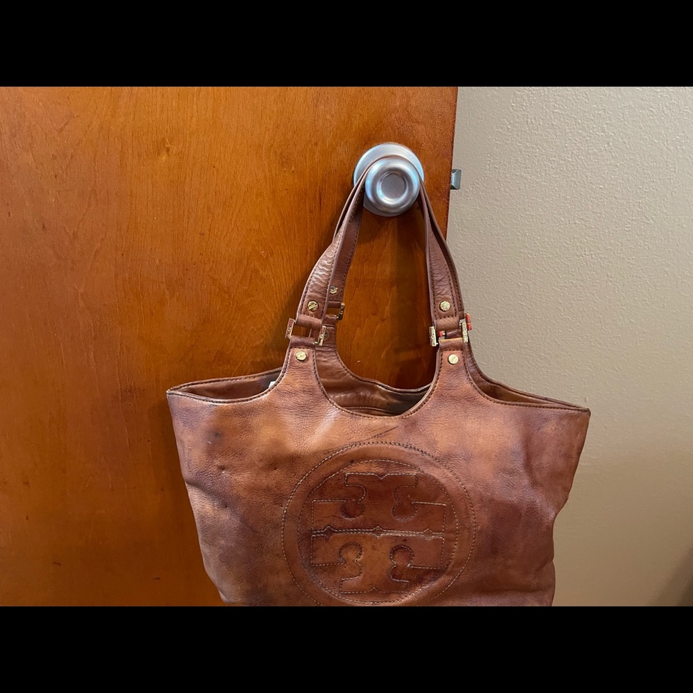 Used brown leather Tory Burch Like bag. Has lots of life left.